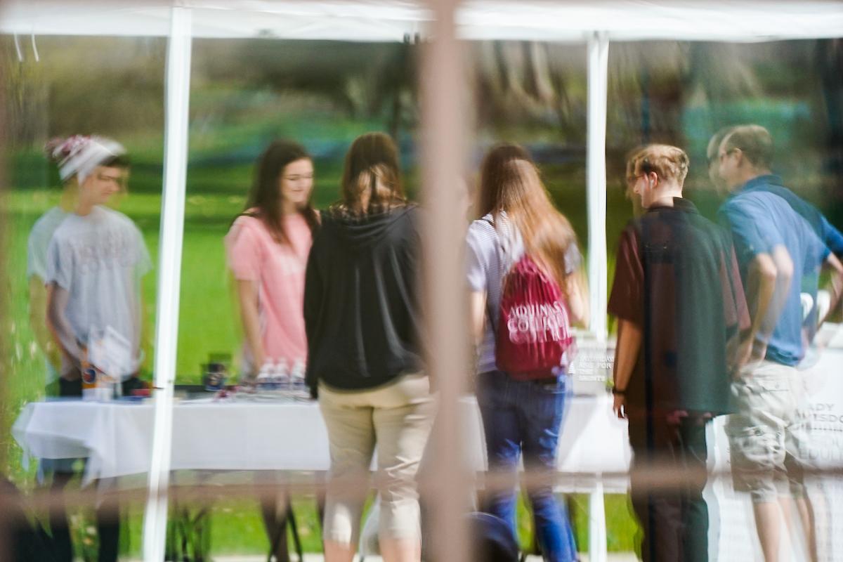 A reflection of students standing at a table